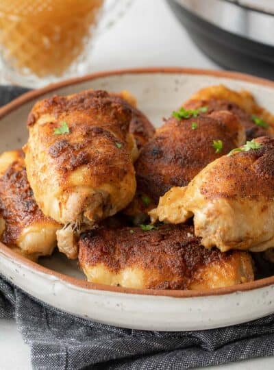 close up view of crispy chicken thighs in dish