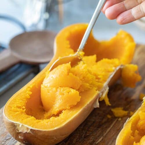 spoon scooping butternut squash from skin