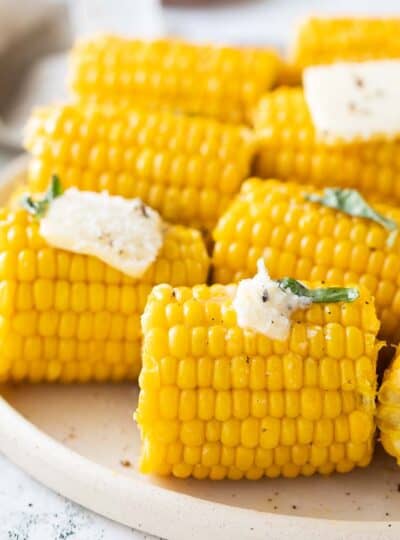 close up view of corn cobs spread with butter