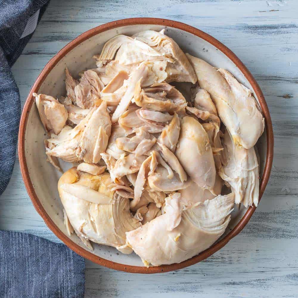 top down shot of boiled chicken in a bowl