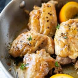 close up view of seasoned chicken thighs in skillet