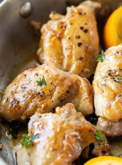 close up view of seasoned chicken thighs in skillet