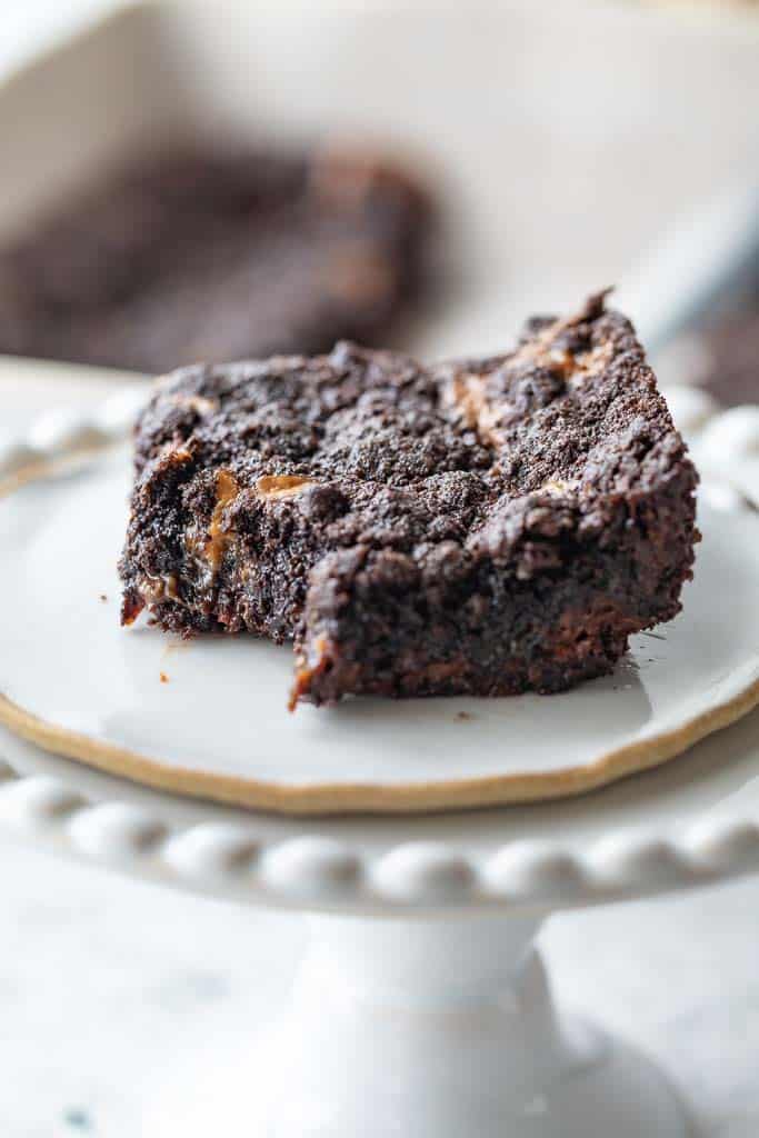 close up view of chocolate caramel bar on cake stand