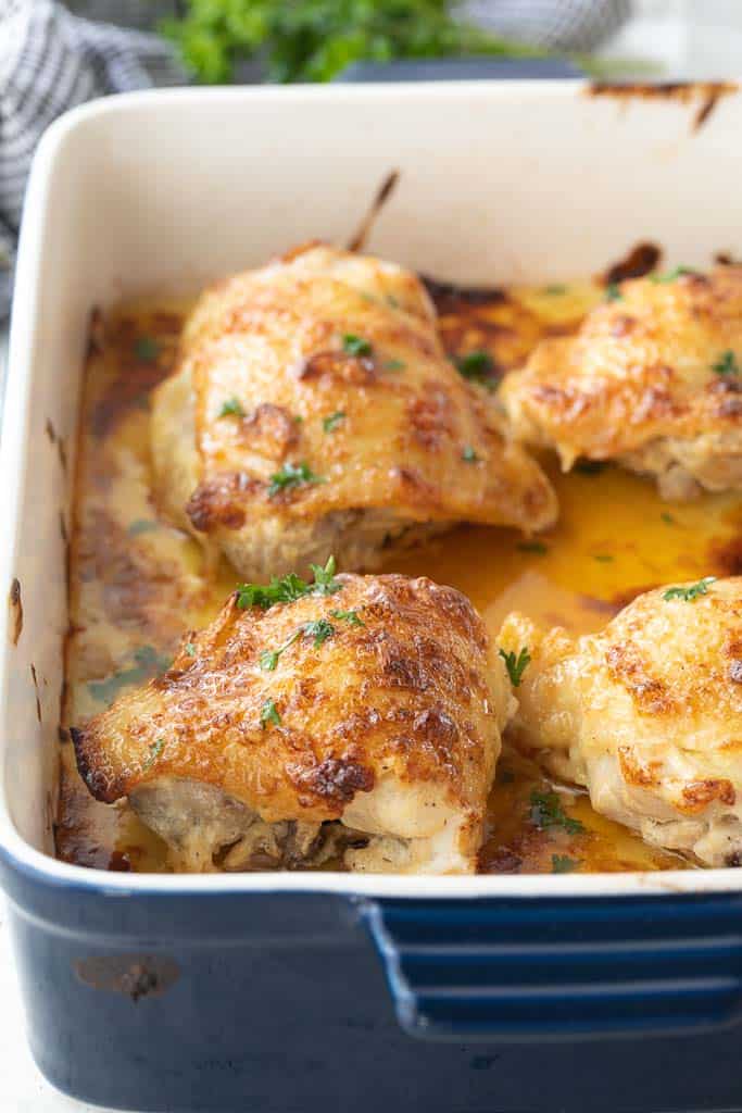 baking dish with seasoned chicken thighs