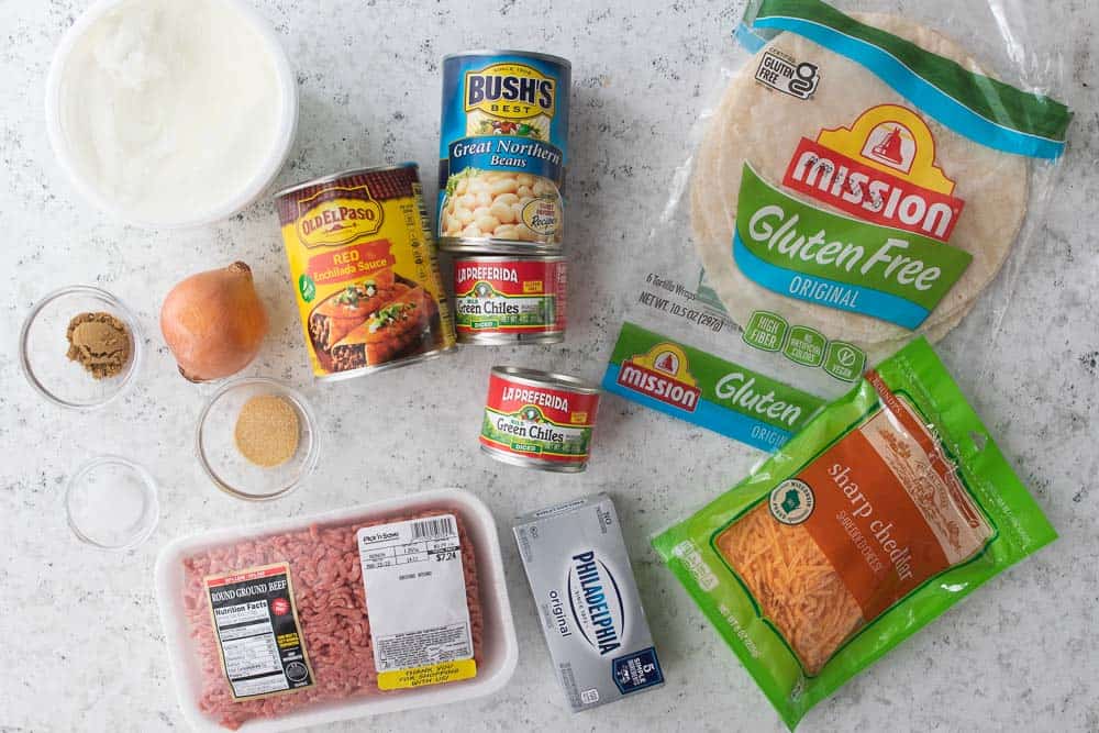 various ingredients for beef enchiladas with gluten free tortillas shown