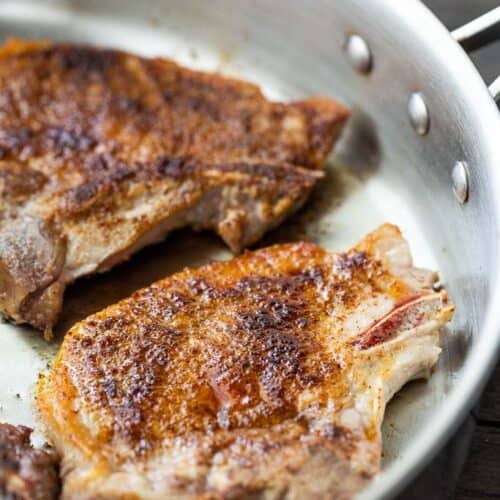 seared pork chops in skillet