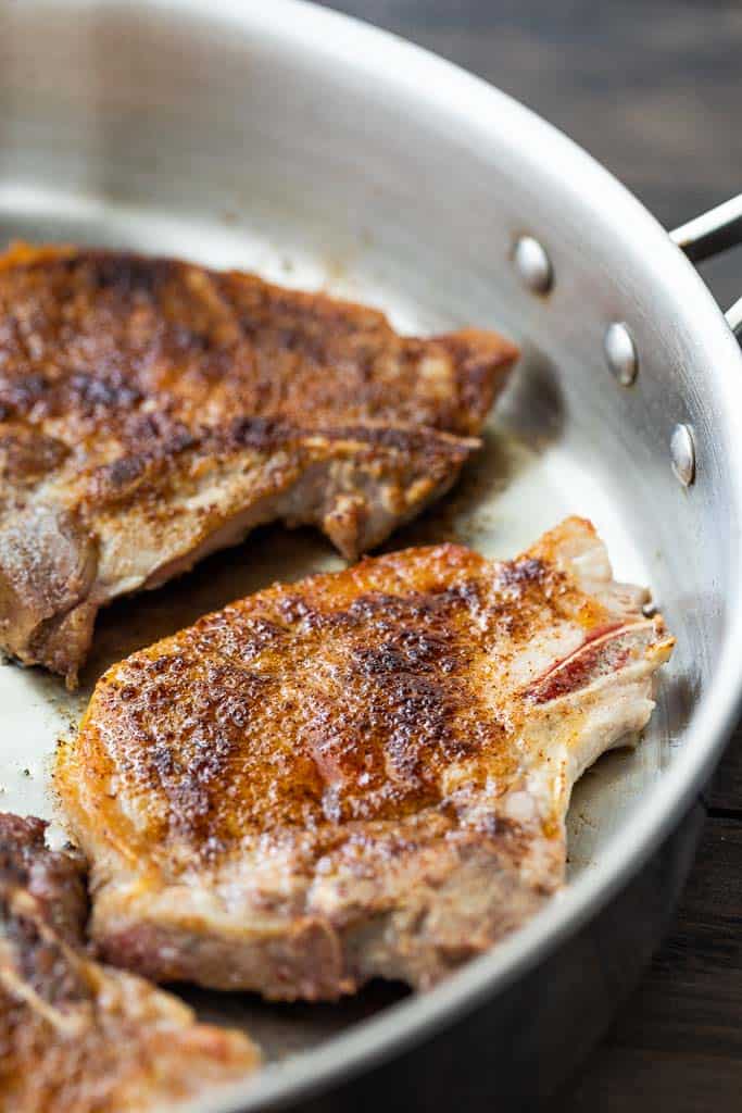 seared pork chops in skillet