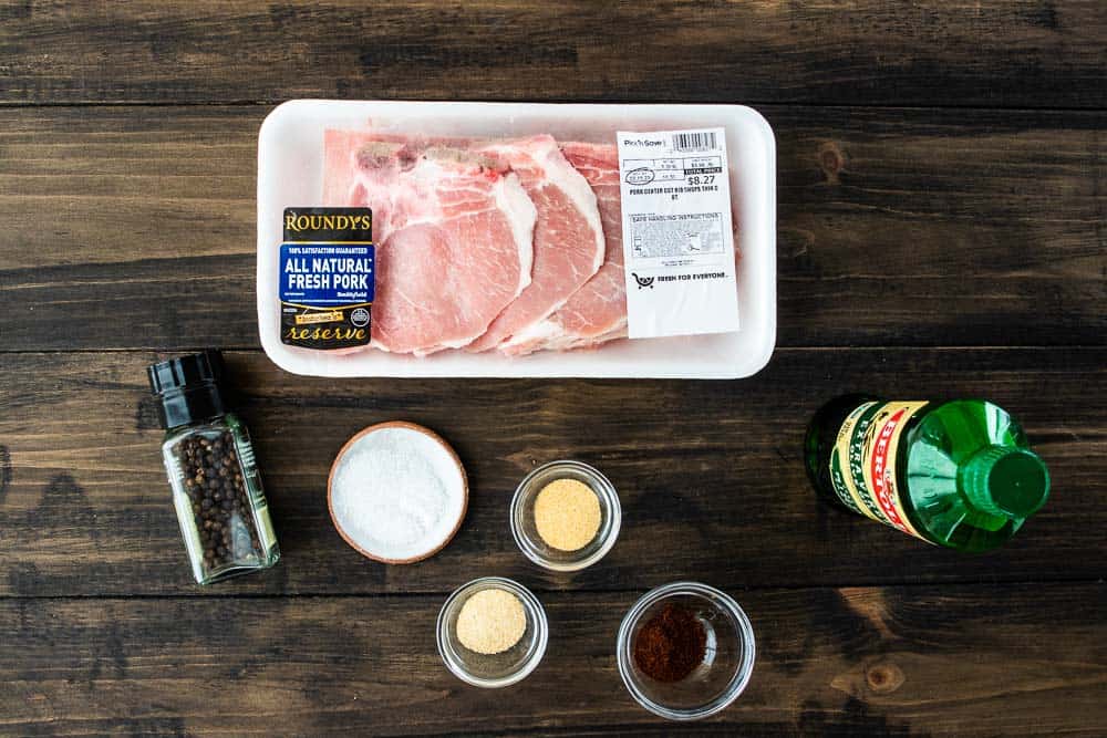 thin pork chops, olive oil and spices on counter