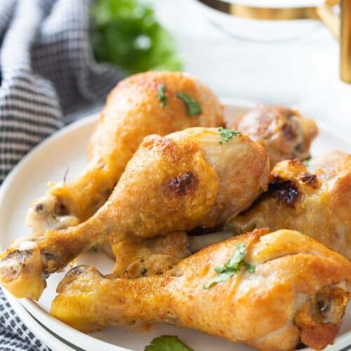 stacked chicken drumsticks on a plate