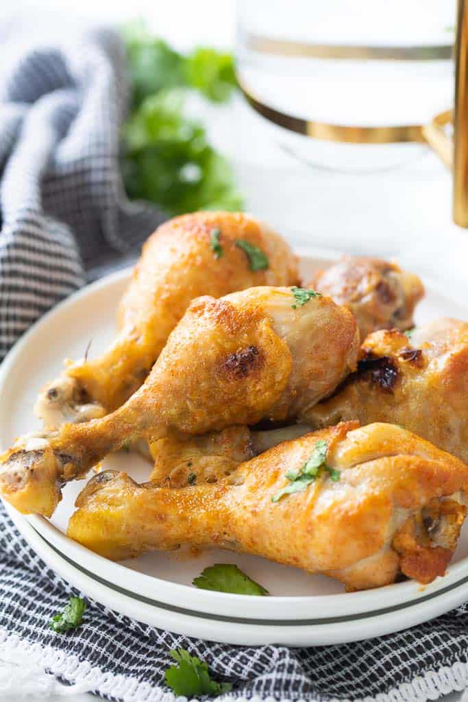 stacked chicken drumsticks on a plate