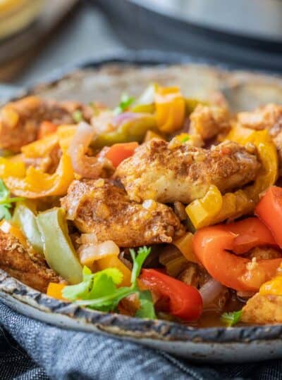 close up of seasoned chicken and sauteed peppers