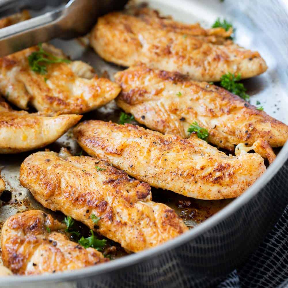 close up view of chicken tenders in a pan