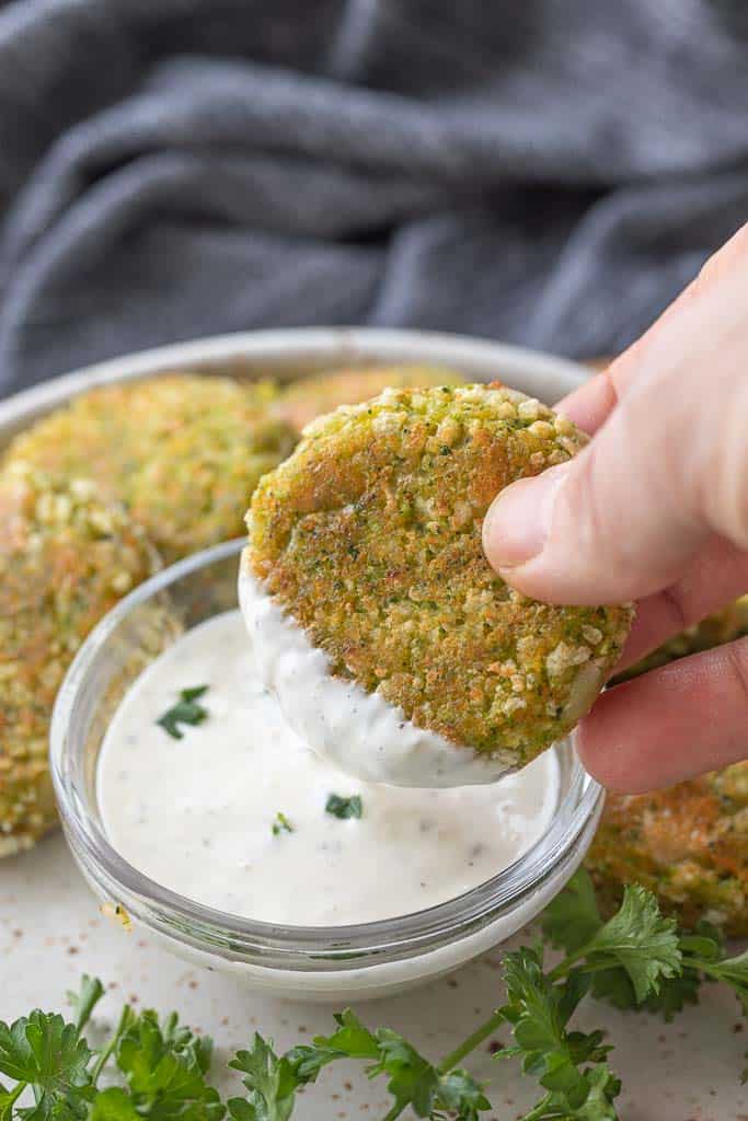 hand dipping veggie nugget in sauce