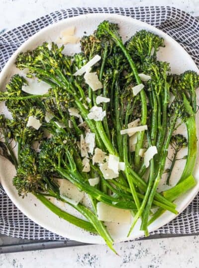 top down view of broccoli topped with grated parmesan on a plate