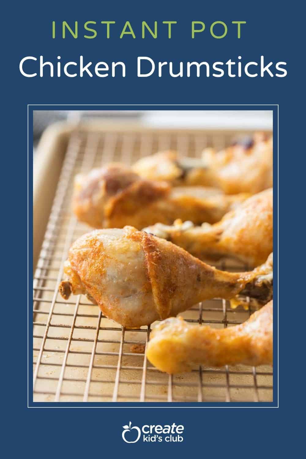 crispy chicken drumsticks on wire rack lined baking sheet