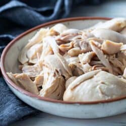 A bowl full of boiled chicken breasts