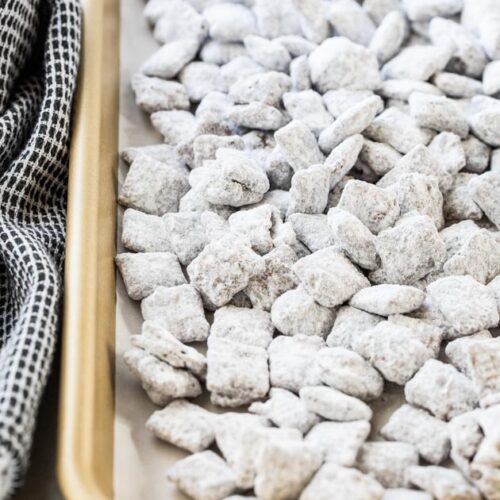 close up of Chex mix muddy buddies on a baking sheet