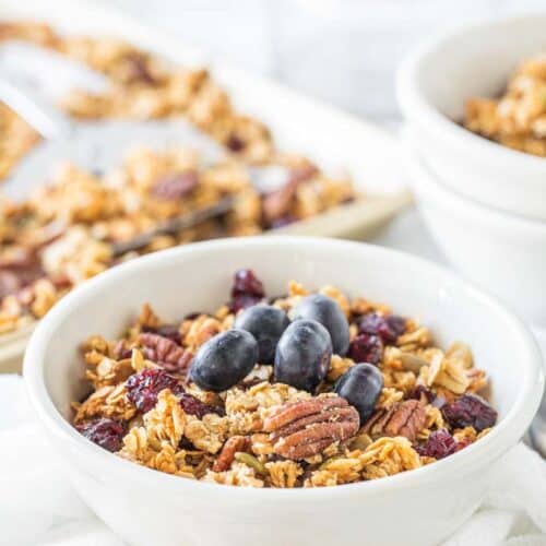 bowl of granola topped with fresh blueberries