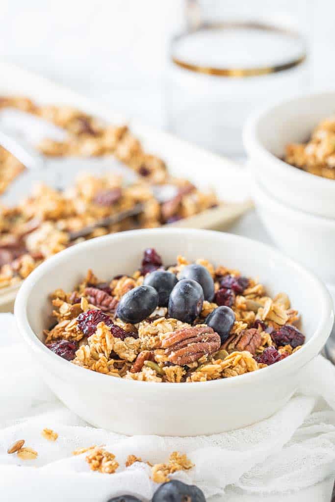 bowl of granola topped with fresh blueberries