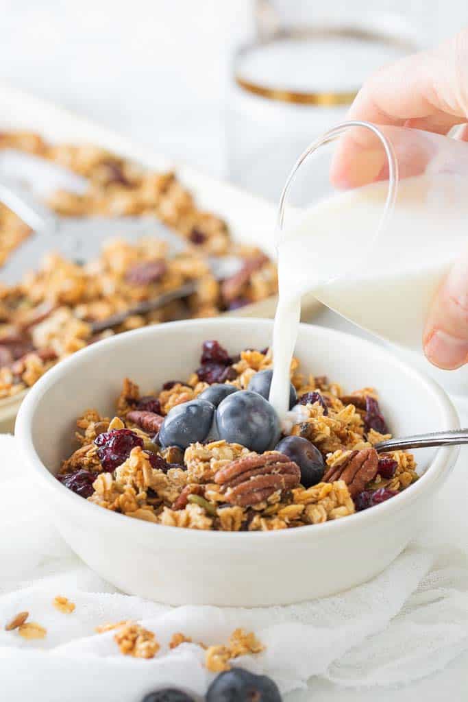 milk poured into bowl of cereal