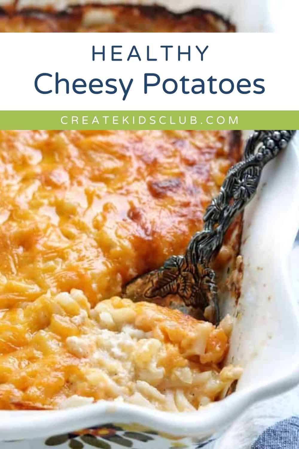 a pin of cheesy potatoes in a casserole pan with a spoon