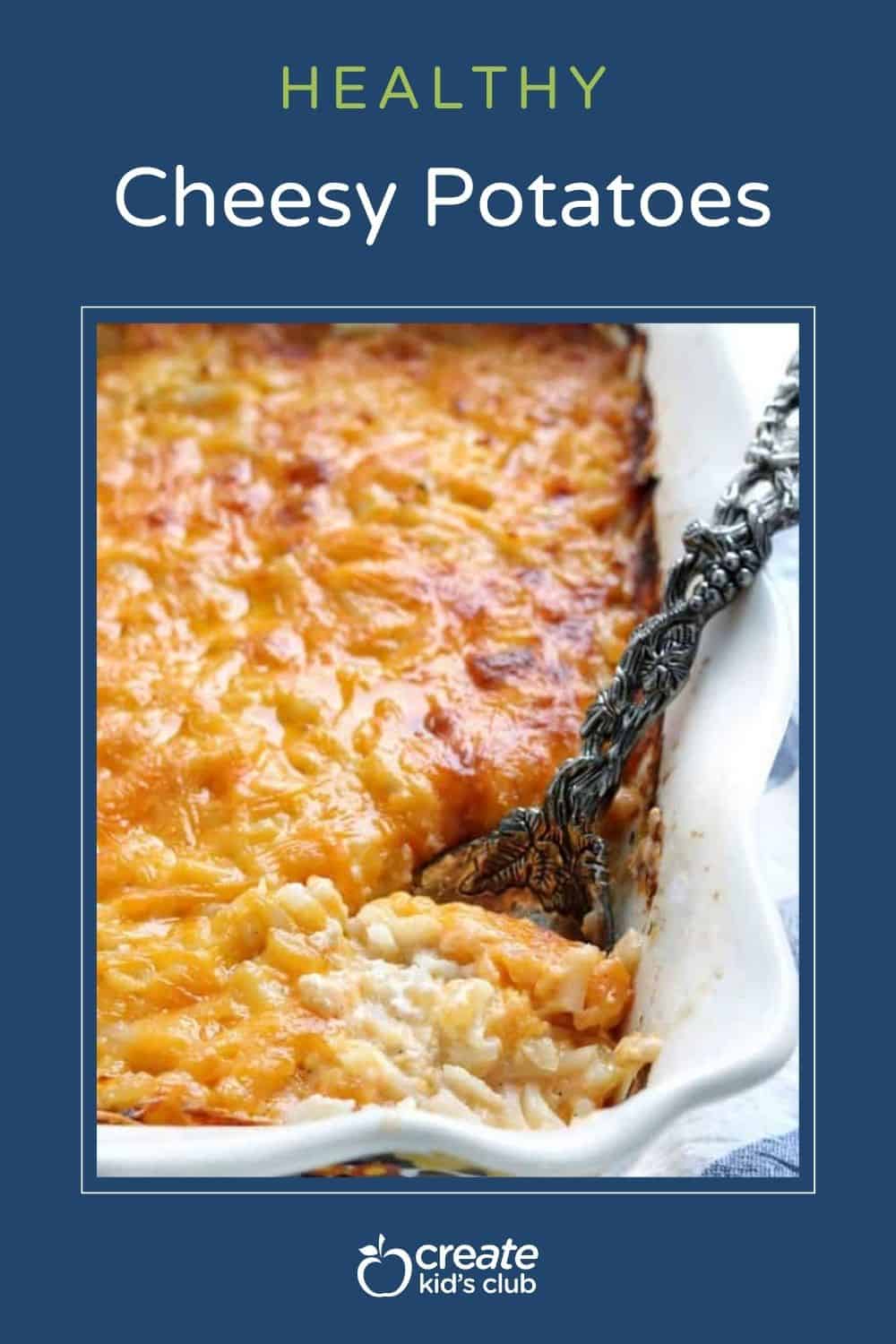 a pin of cheesy potatoes in a casserole pan with a spoon