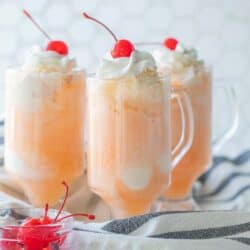 three ice cream floats in glass cups