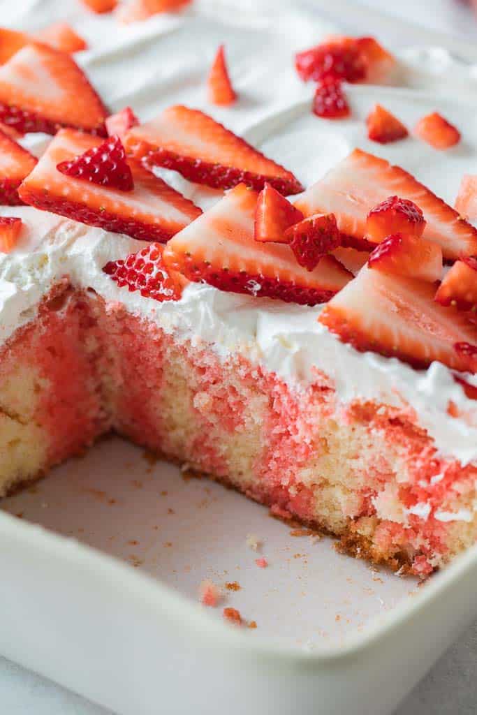 strawberry cake in dish with missing piece