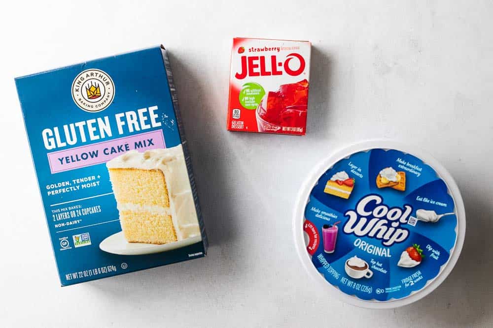 yellow cake mix, strawberry jello mix and cool whip container displayed