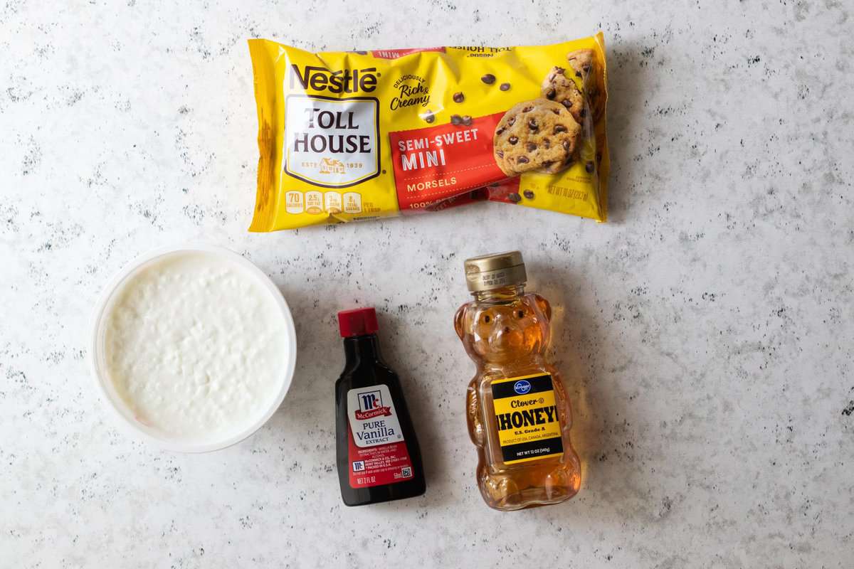 cottage cheese, vanilla extract, honey and mini chocolate chips displayed on counter