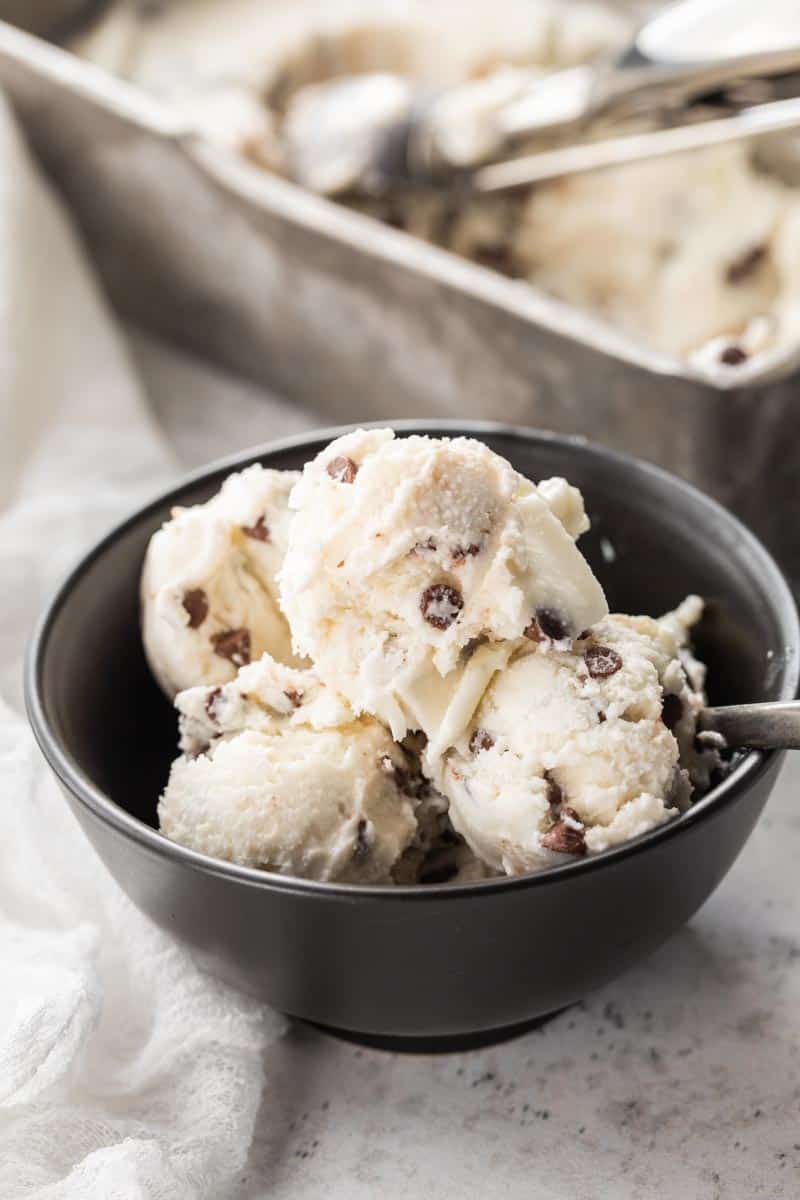 multiple scoops of chocolate chip ice cream in bowl with spoon