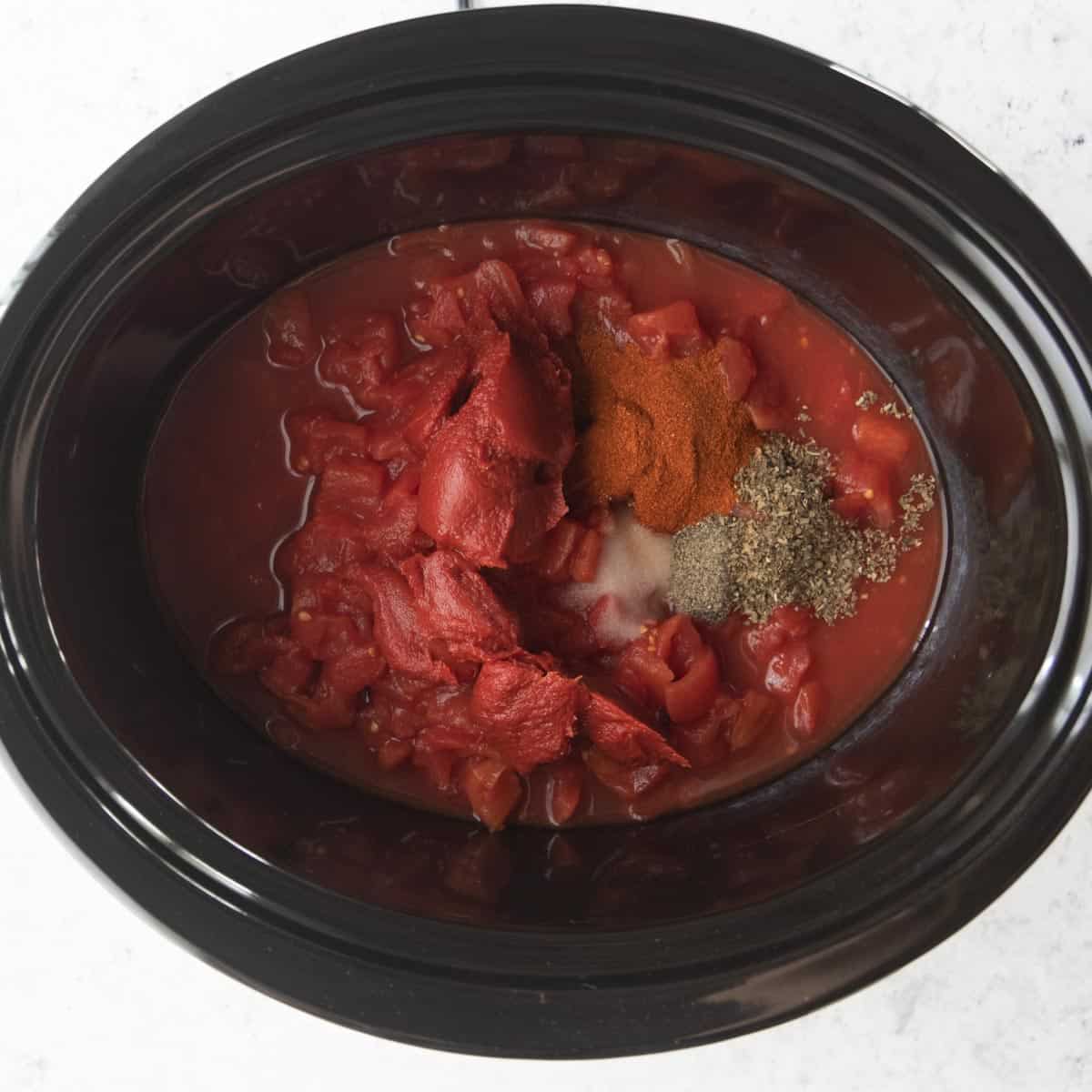 diced tomatoes, tomato paste and spices in slow cooker