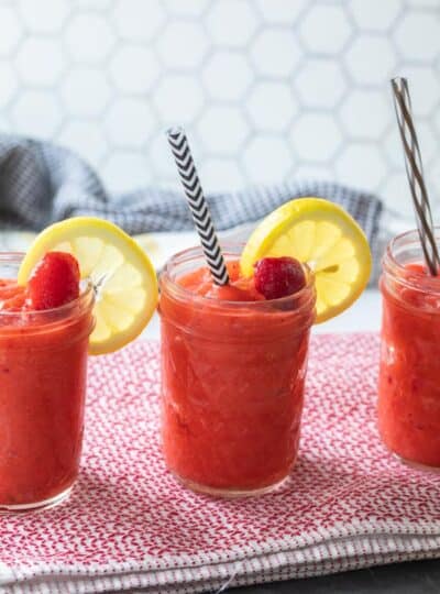 glass jars filled with frozen strawberry slushies