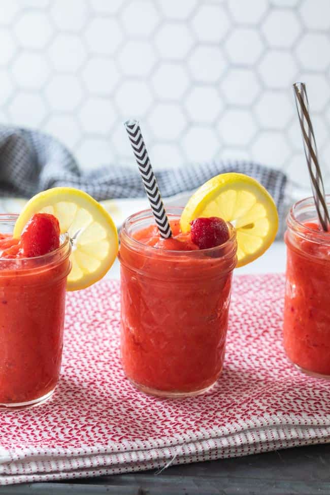 glass jars filled with frozen strawberry slushies