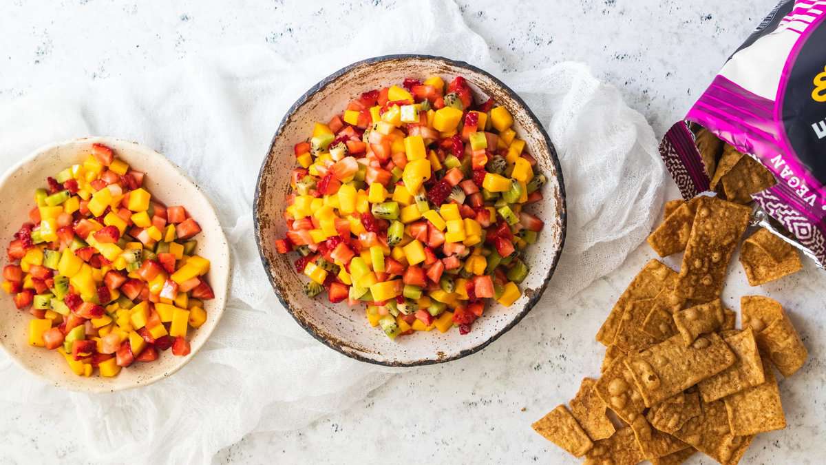 fruit salsa split between two bowls next to cinnamon chips