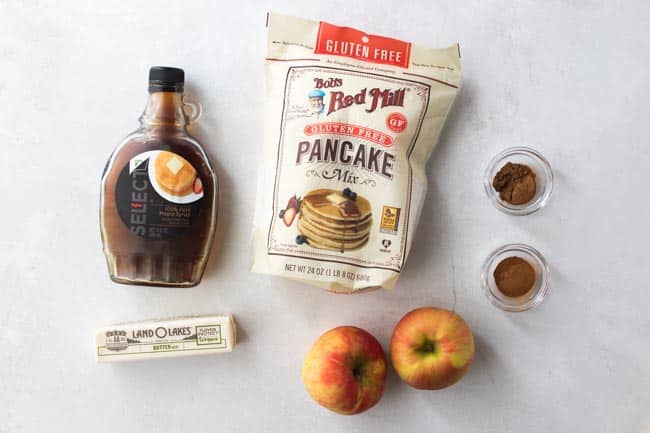 maple syrup, pancake mix, cinnamon, apples and butter displayed