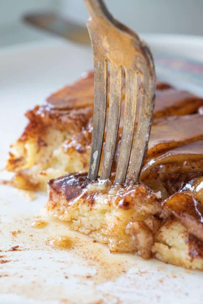 fork scooping up bite of apple pancake