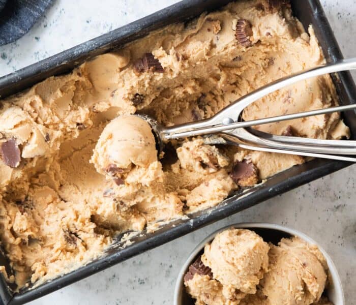 top down shot of ice cream scoop in pan of ice cream