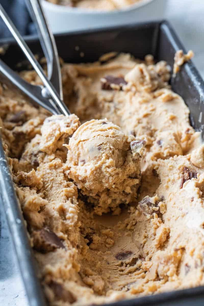 ice cream scoop scooping peanut butter ice cream from pan
