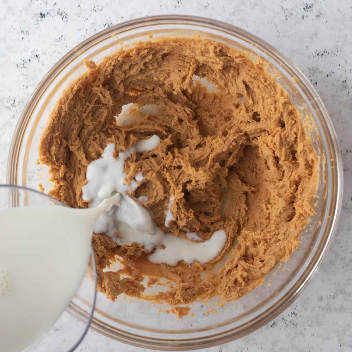 milk poured into whipped peanut butter