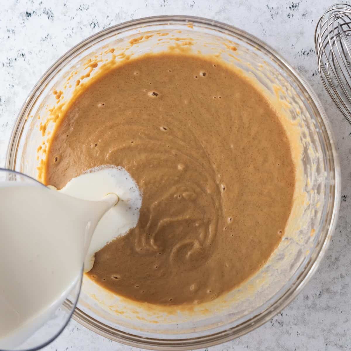 milk poured into peanut butter mixture in bowl