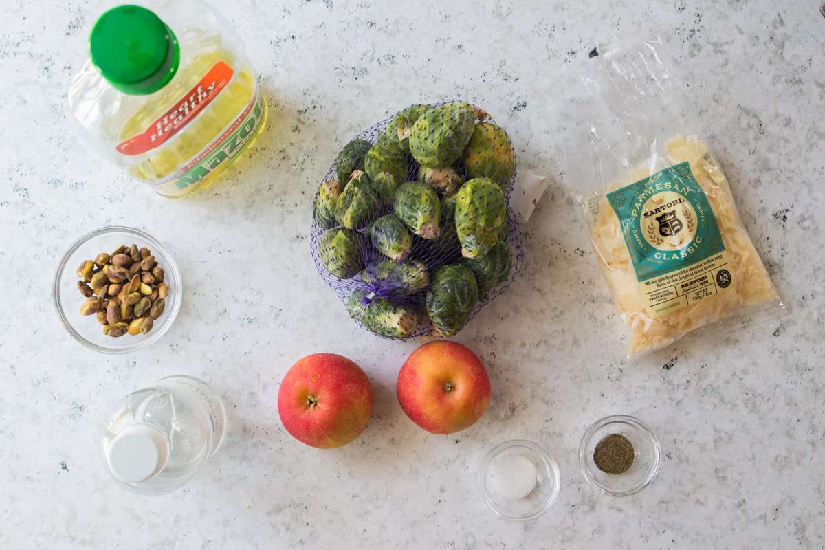 vegetable oil, pistachios, vinegar, apple, parmesan cheese, brussels sprouts, salt and pepper displayed on counter