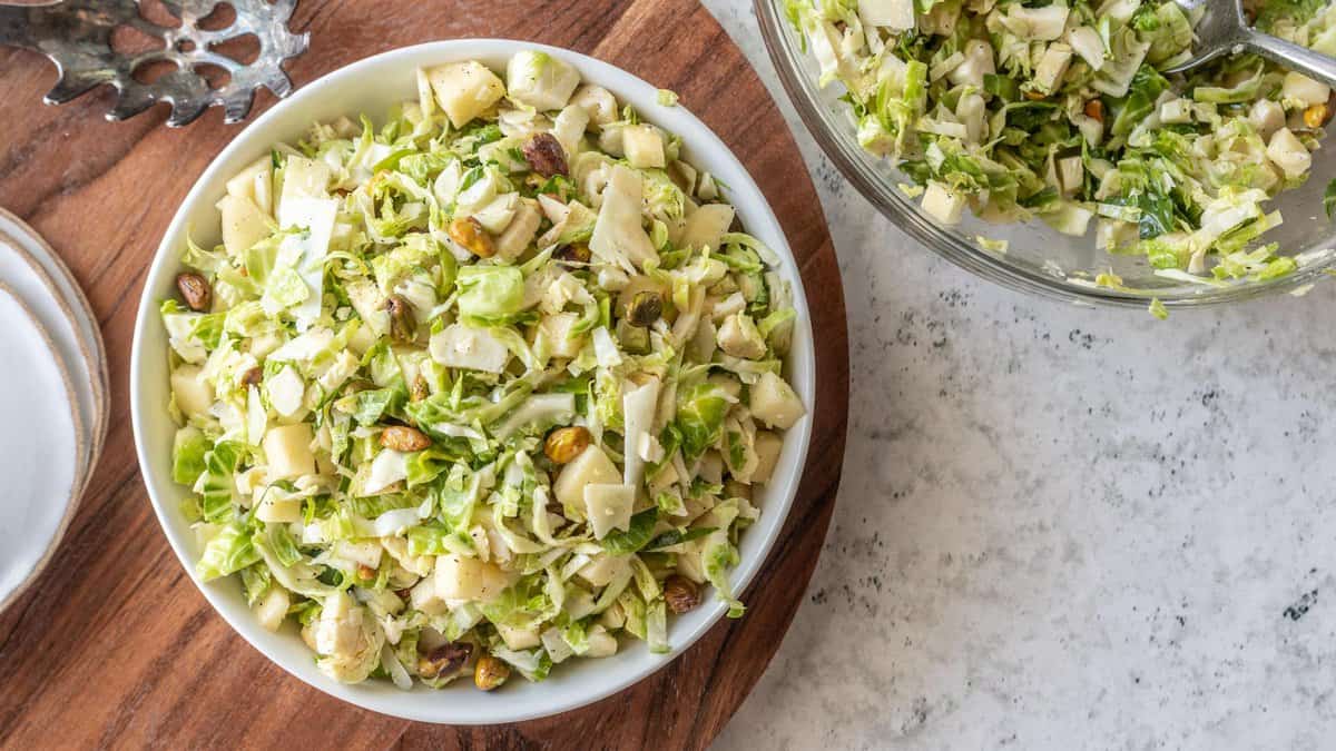 top down view of shaved brussels sprouts salad in large mixing bowl