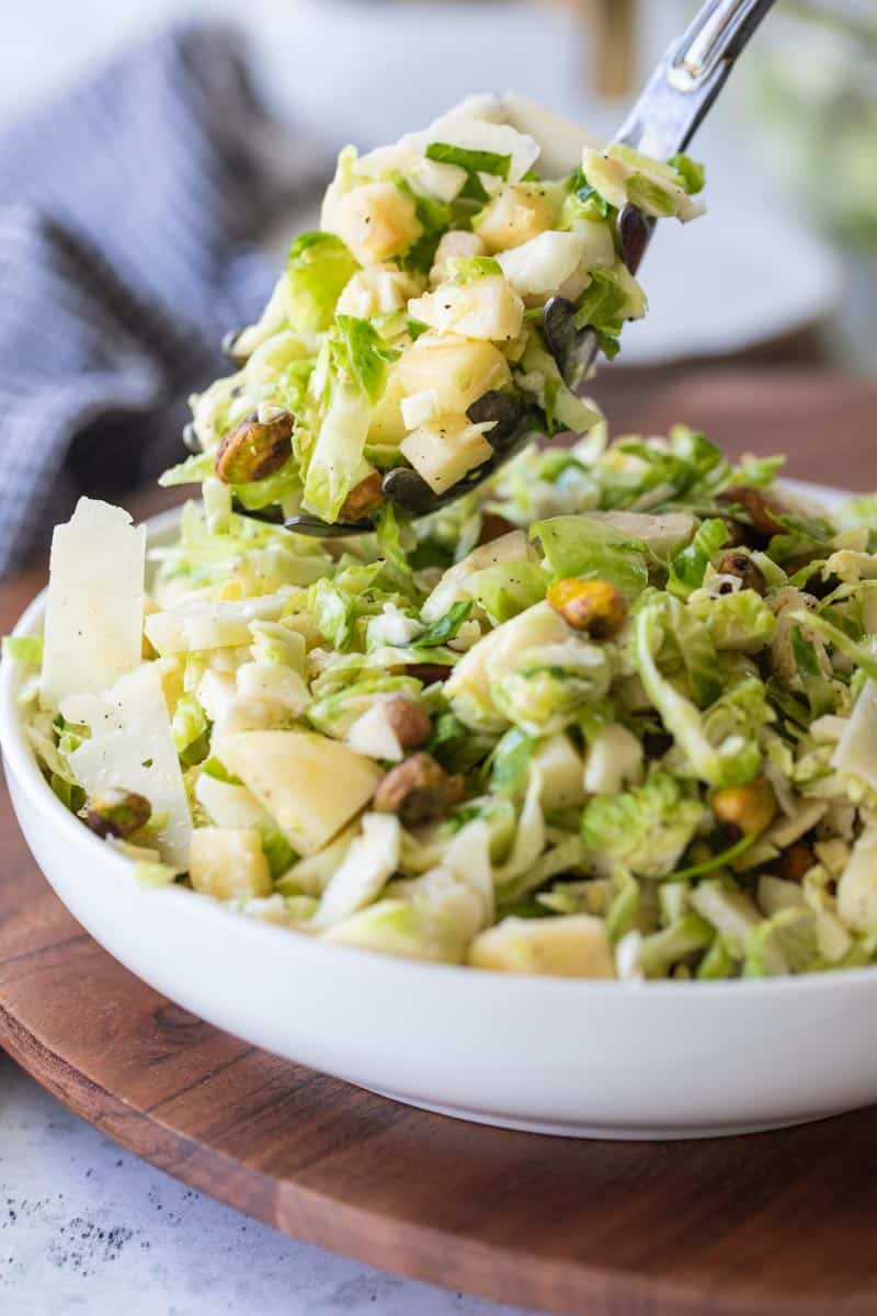 spoon scooping brussels sprout salad from bowl