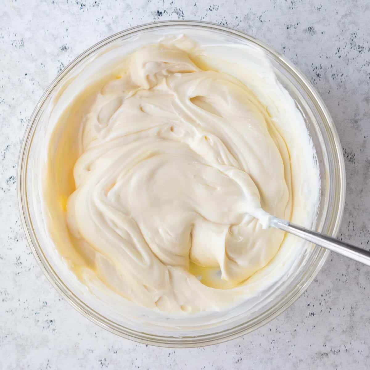 cool whip mixture in mixing bowl with spoon