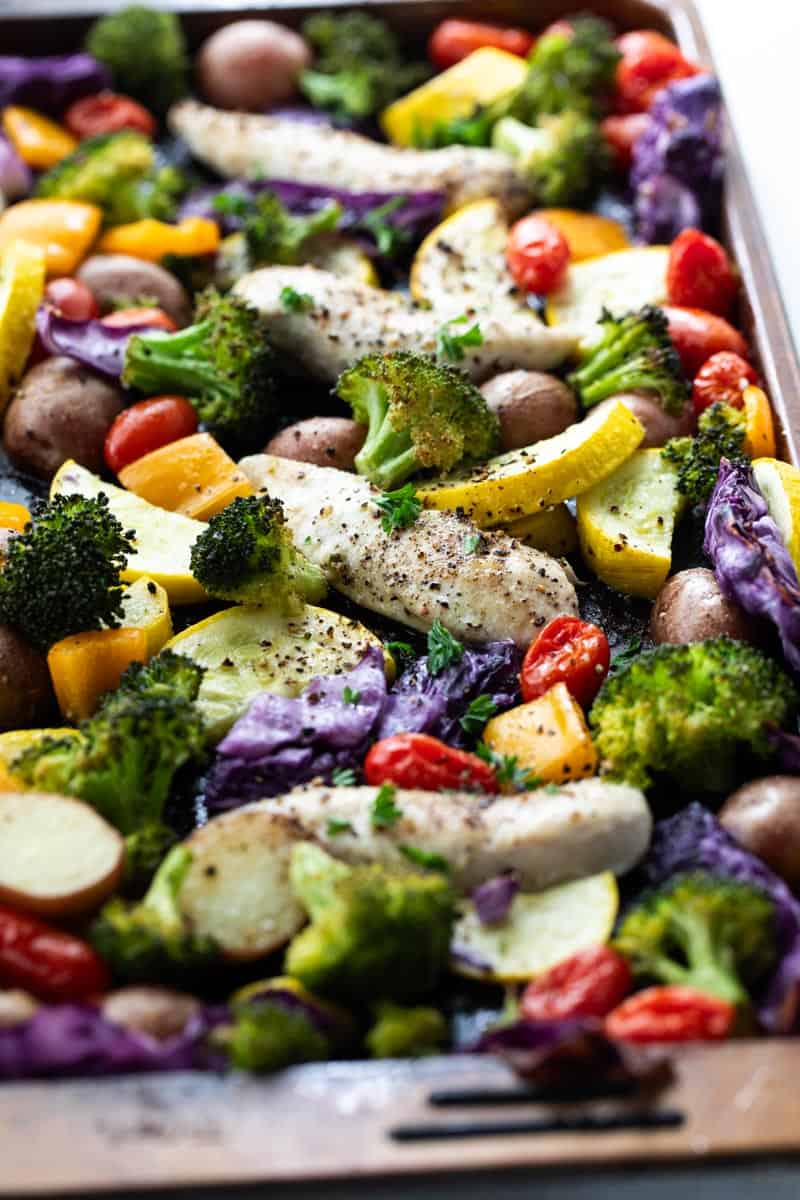 sliced vegetables on sheet pan with chicken