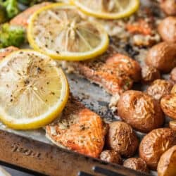 roasted red potatoes, salmon filets and broccoli on a sheet pan