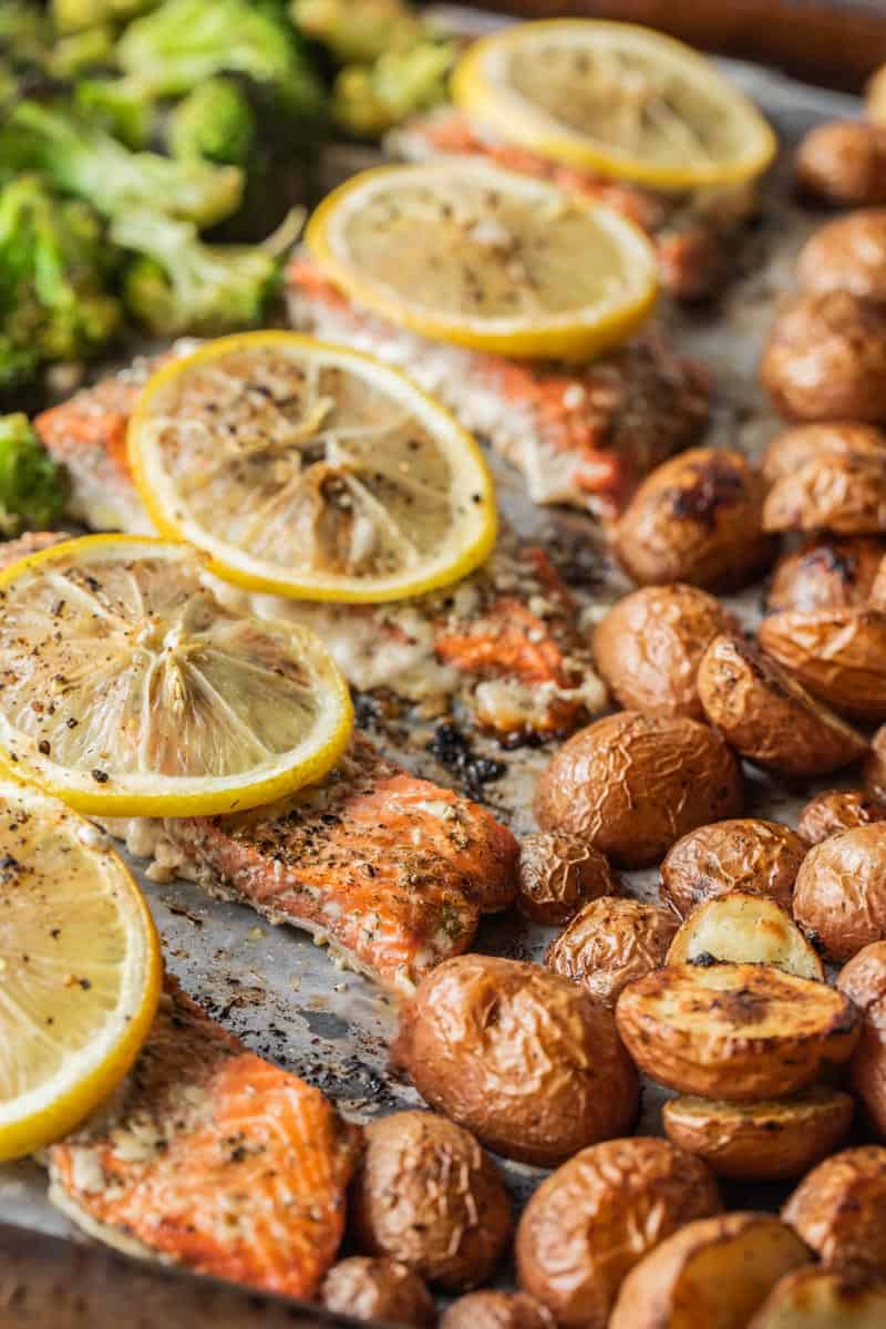 roasted red potatoes, salmon filets and broccoli on a sheet pan