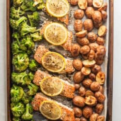 close up view of roasted broccoli, salmon and red potatoes