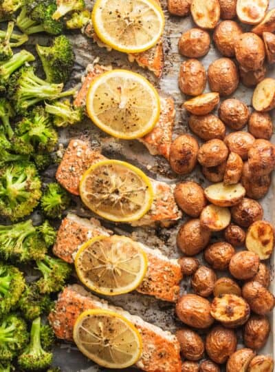 close up view of roasted broccoli, salmon and red potatoes